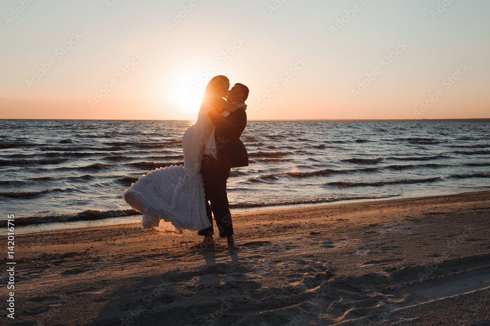 Just Married. Beautiful young couple on the beach at sunset
