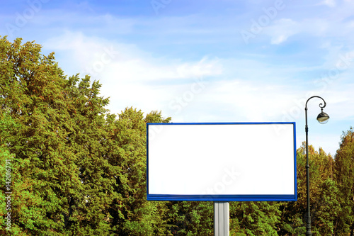 Empty billboard against green landscape