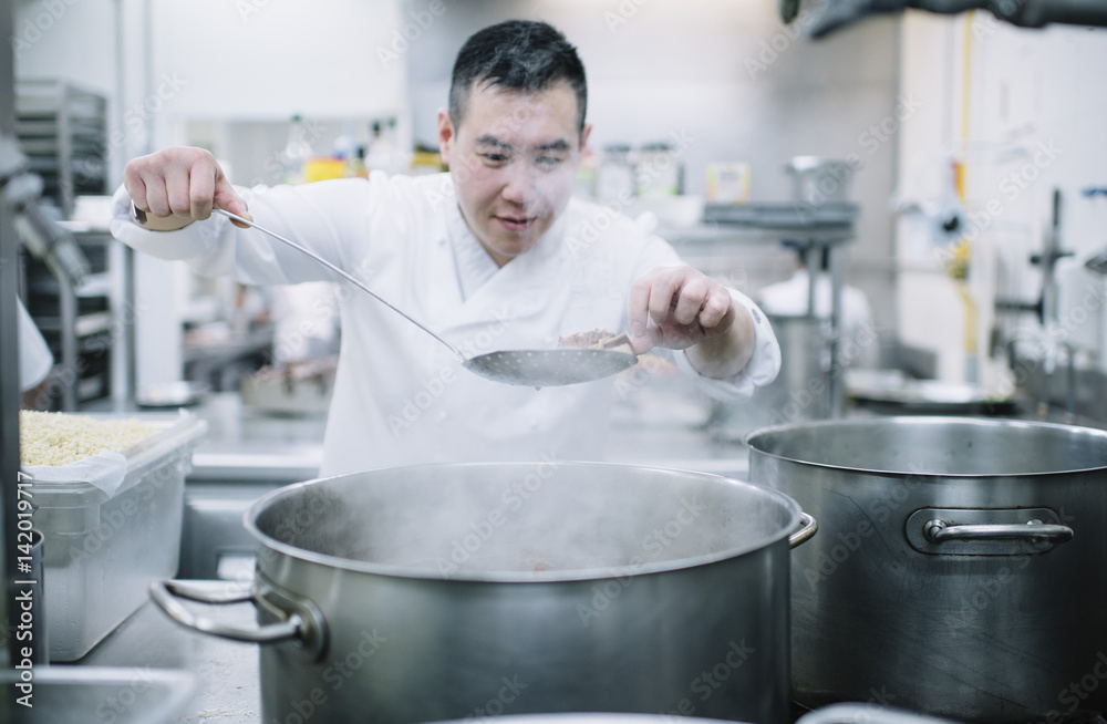 Chinese cook preparing stew in the pan Chinese cook preparing stew in the pan