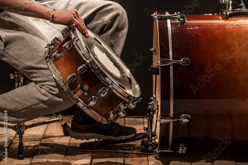 man adjusts percussion instruments, creative music concept