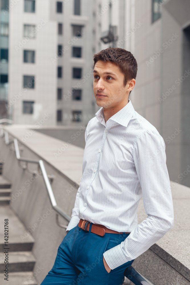 Handsome mature businessman outdoor. Portrait of an young businessman in an urban setting. Handsome mature businessman outdoor. Portrait of an young businessman in an urban setting.