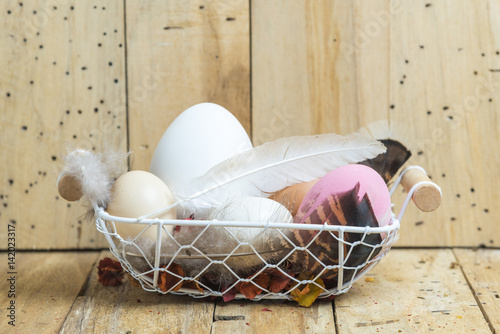 easter eggs in a basket wit...