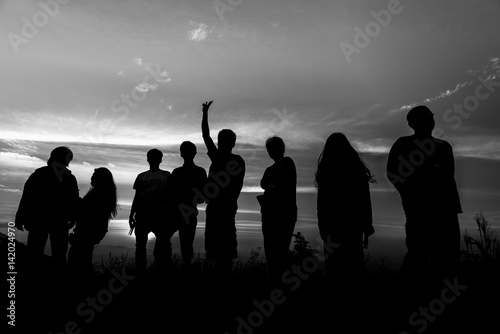 Silhouette of a group of people at sunset,black and white