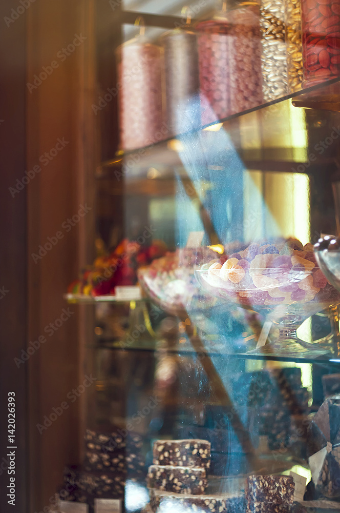 Rich variety of chocolates and candies in display window  of italian pastry shop