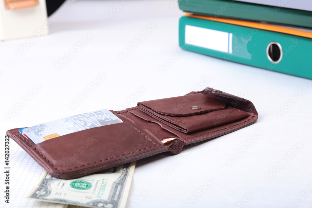 leather wallet with credit cards, Folder file, and note on the desk. blurred background. leather wallet with credit cards, Folder file, and note on the desk. blurred background.