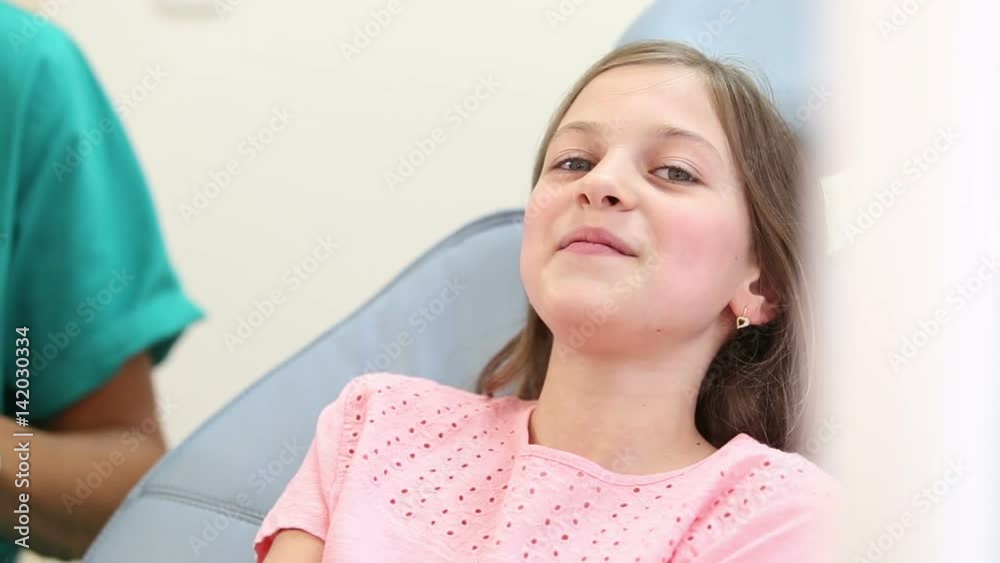 Happy cute girl showing thumbs up at dentist Happy cute girl showing thumbs up at dentist