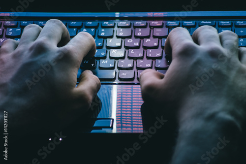 Photography Russian hacker hacking the server in the dark