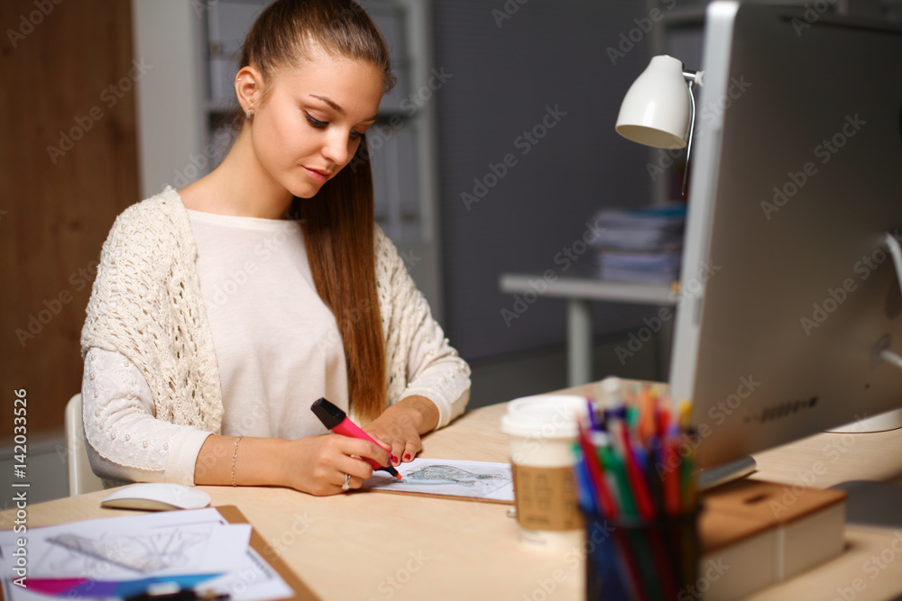 Young woman working in office, sitting at desk Young woman working in office, sitting at desk