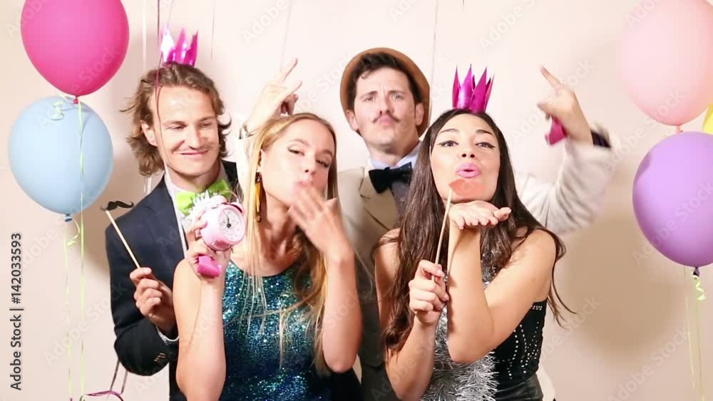 Group of beautiful happy friends in party photo booth, graded Group of beautiful happy friends in party photo booth, graded