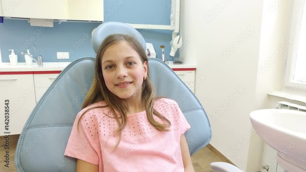 Close up of father and daughter playing with dental X- ray photo at dentist