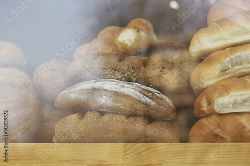 Assorted bread in shop window, low contrast