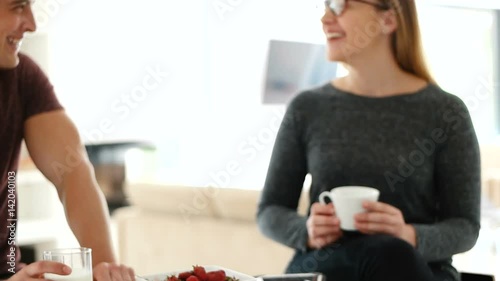 couple enjoying time together while eatinga and using technology photo