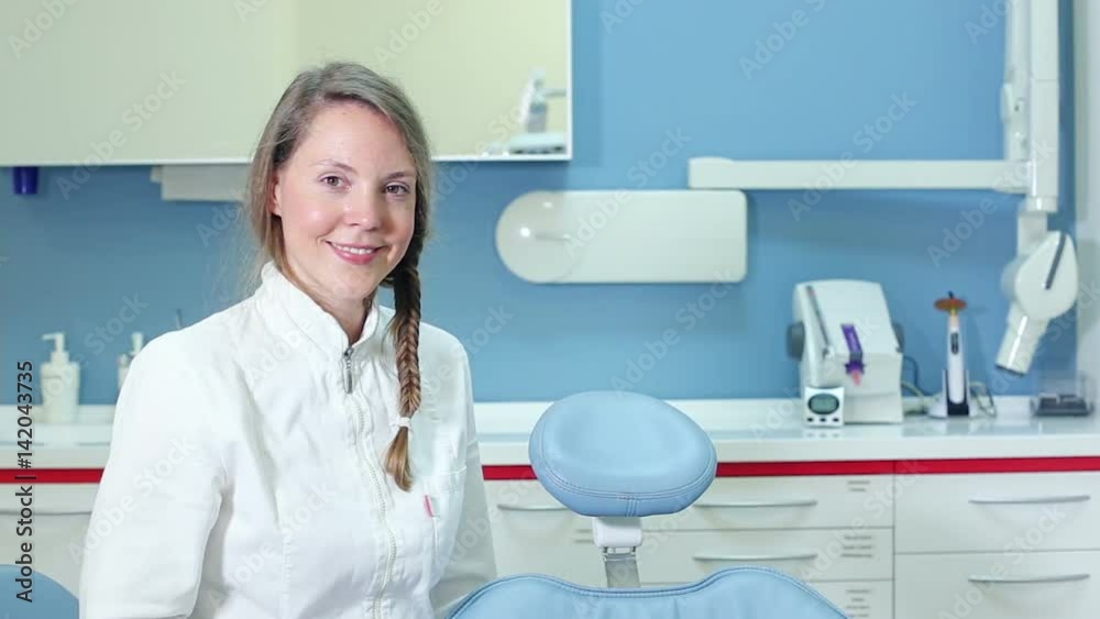Portrait of beautiful smiling female dentist, graded Portrait of beautiful smiling female dentist, graded