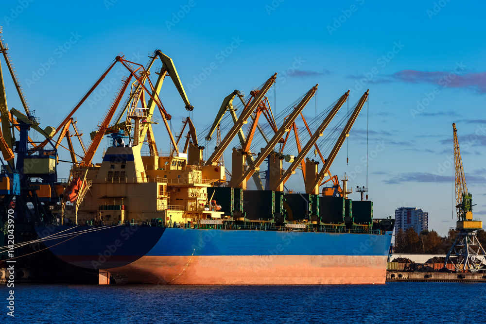 Fototapeta premium Blue cargo ship loading in the port of Riga, Europe
