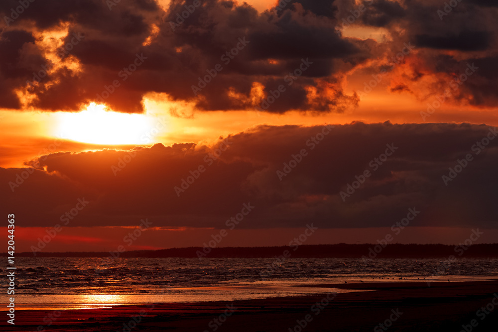 Orange cloudy sunset sky over the Baltic sea