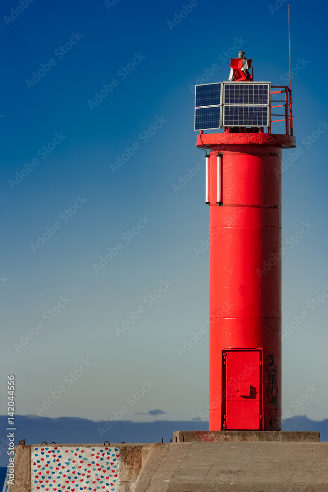 Red lighthouse on breakwater dam in Riga, Europe