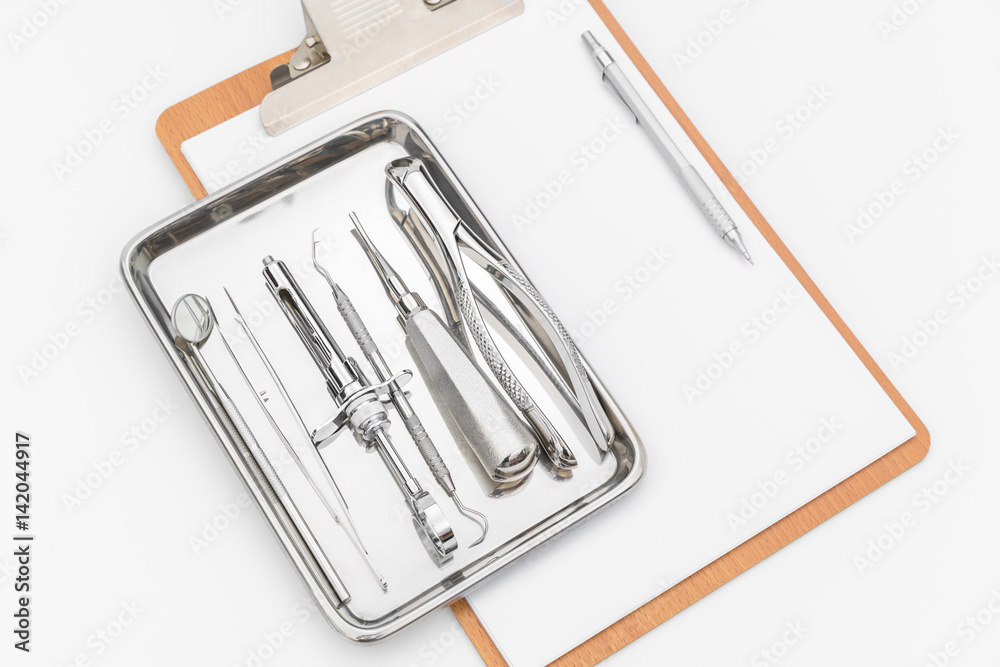 Dental tools, equipment and dental chart on white background Dental tools, equipment and dental chart on white background