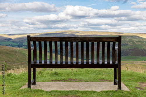 Bench with view over the Yorkshire Dales, near Thwaite, North Yorkshire, UK