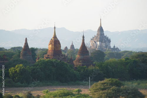 Tops of ancient Buddhist temples in an evening haze. Bagan, Myanmar