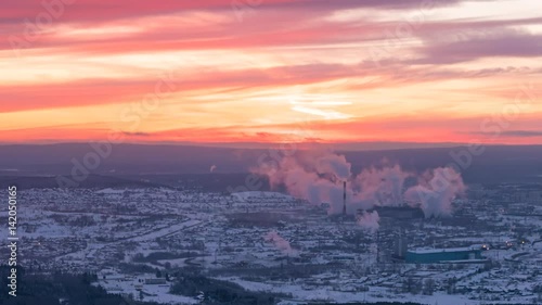 Sunset over the industrial city. The smoke from the chimneys. Revda, Ekaterinburg, Russia. Time Lapse
 photo