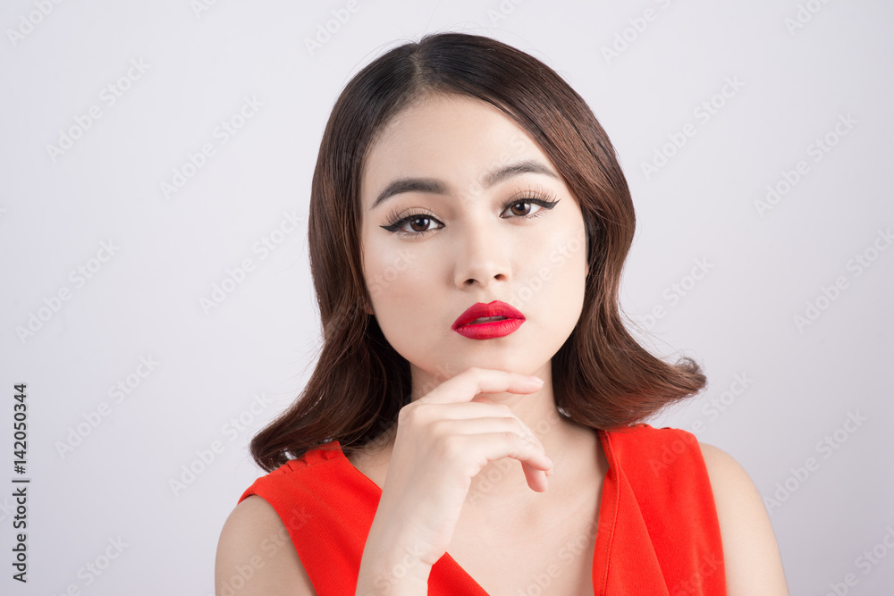 Fashion studio portrait of gorgeous sensual asian woman with dark hair wears elegant red dress Fashion studio portrait of gorgeous sensual asian woman with dark hair wears elegant red dress