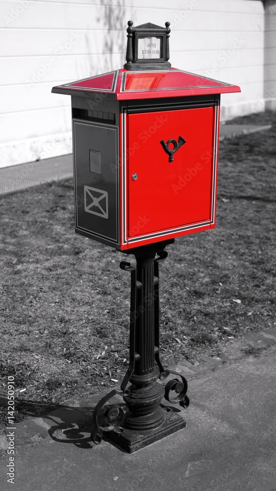 A typical red letter-box in Budapest on black and white background A typical red letter-box in Budapest on black and white background