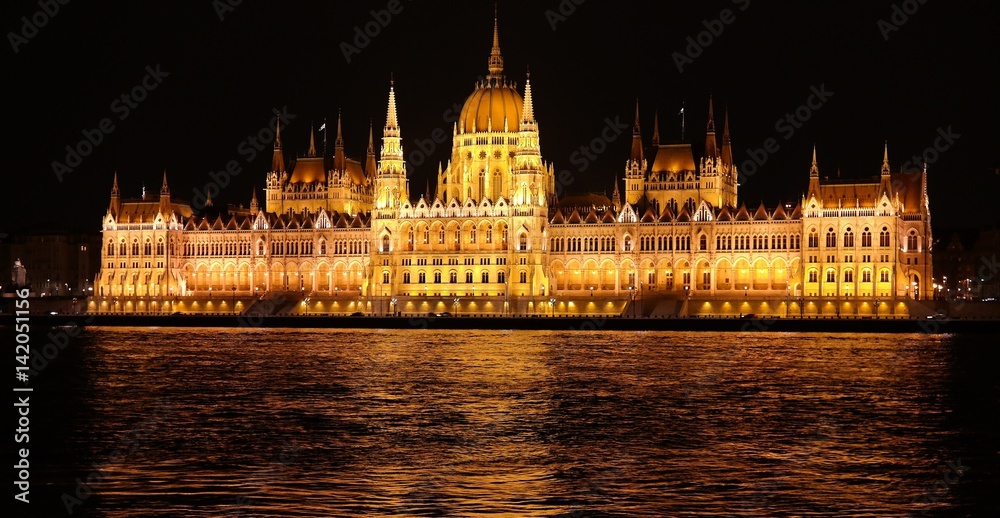 Night scene of Parliament building and Danube river in Budapest