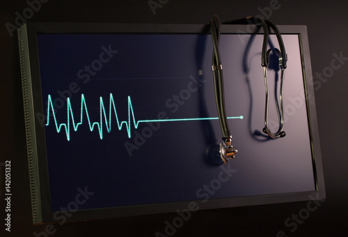 Fading cardiogram and stethoscope on the monitor