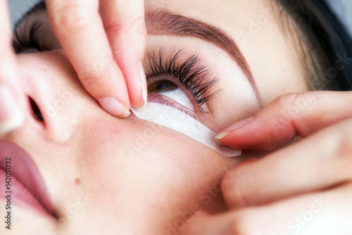 Beautician making artificial lashes. eyelash extension procedure