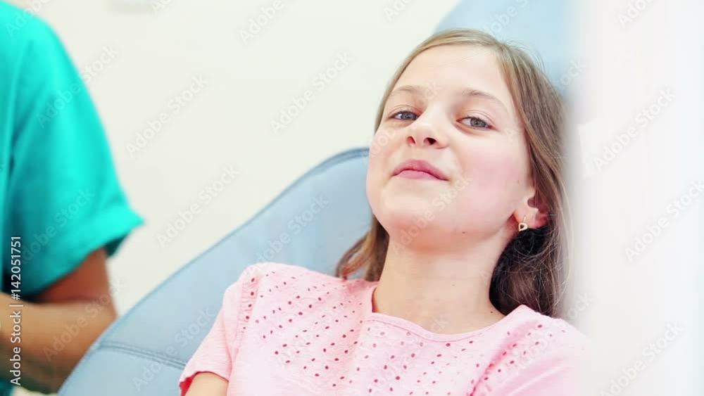 Happy cute girl showing thumbs up at dentist, graded Happy cute girl showing thumbs up at dentist, graded