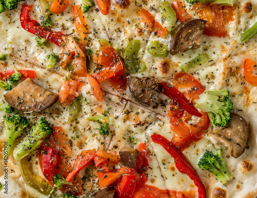 Hot steaming pizza with vegetables, closeup, topview