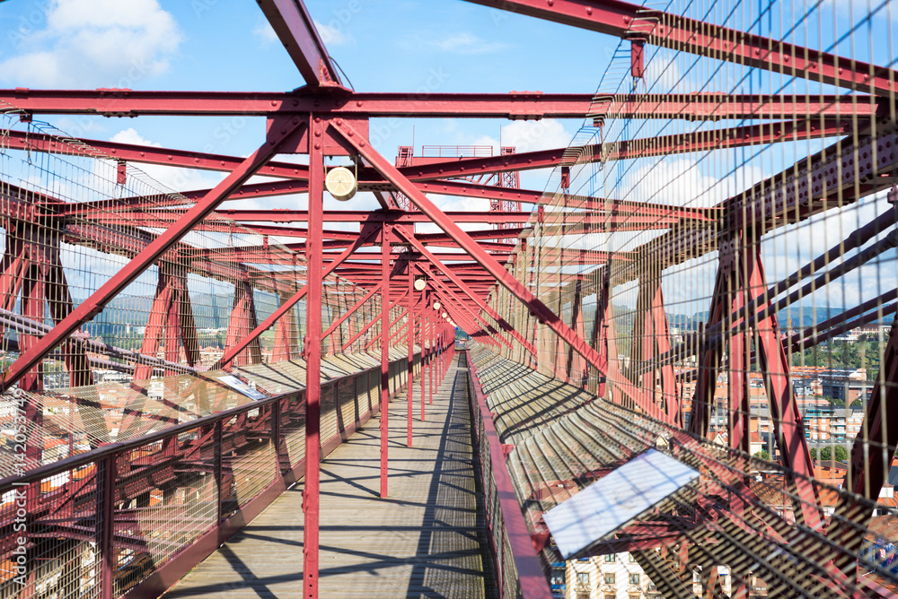 View along the top of the bridge. The Vizcaya Bridge, the worlds oldest transporter bridge, built in 1893, links the towns Portugalete and Las Arenas in the Basque Country, in the north of Spain View along the top of the bridge. The Vizcaya Bridge, the worlds oldest transporter bridge, built in 1893, links the towns Portugalete and Las Arenas in the Basque Country, in the north of Spain