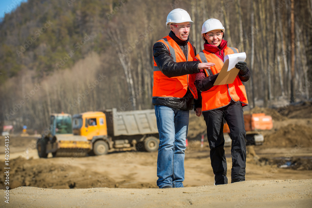 Road workers inspecting construction Road workers inspecting construction