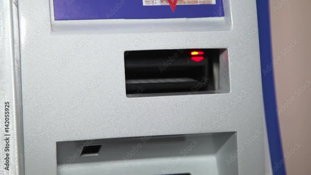 Human hand push russian money to ATM cash in Human hand push russian money to ATM cash in