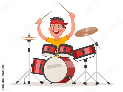 Boy playing drums on a white background. Musical children's performance