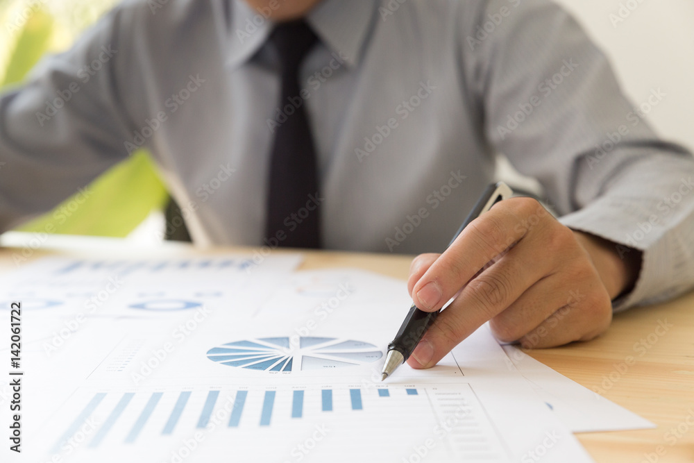 Businessman analyzing charts and graphs Businessman analyzing charts and graphs