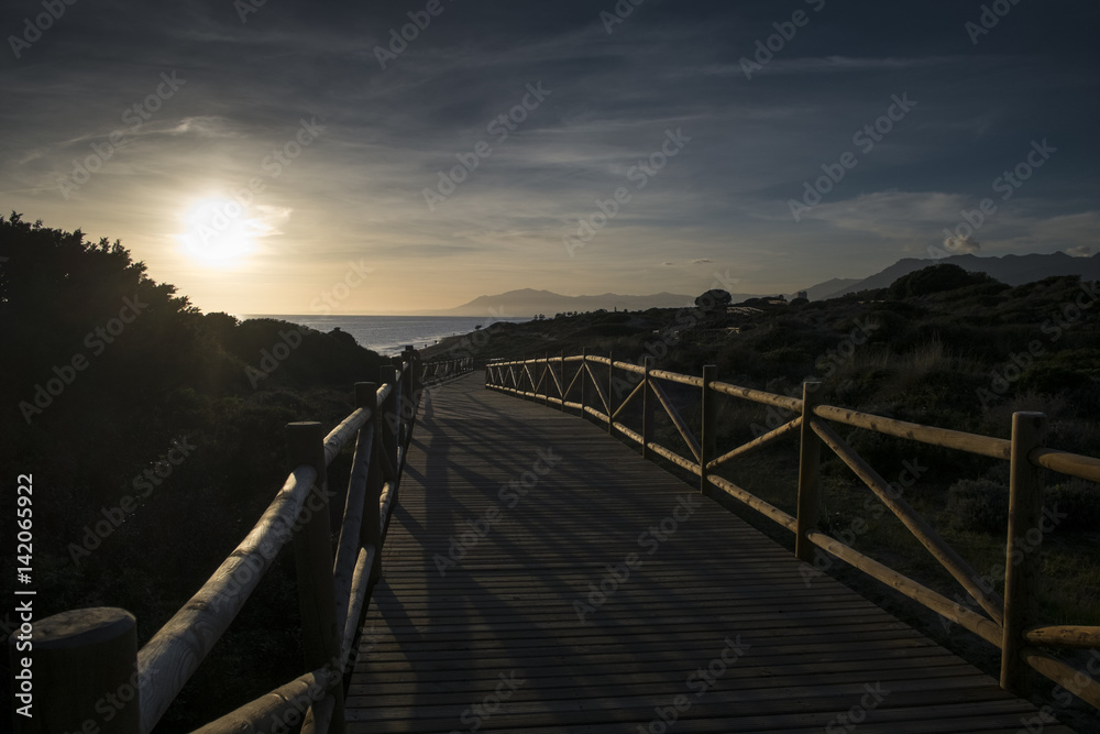 Sunset from wooden path in the natural park of Cabopino, Marbella, Costa del Sol, Málaga province, Andalusia, Spain