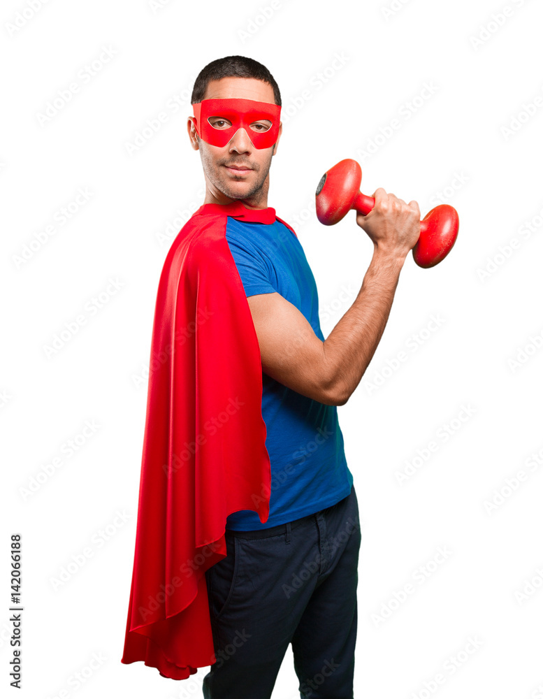 Confident superhero with a dumbbell