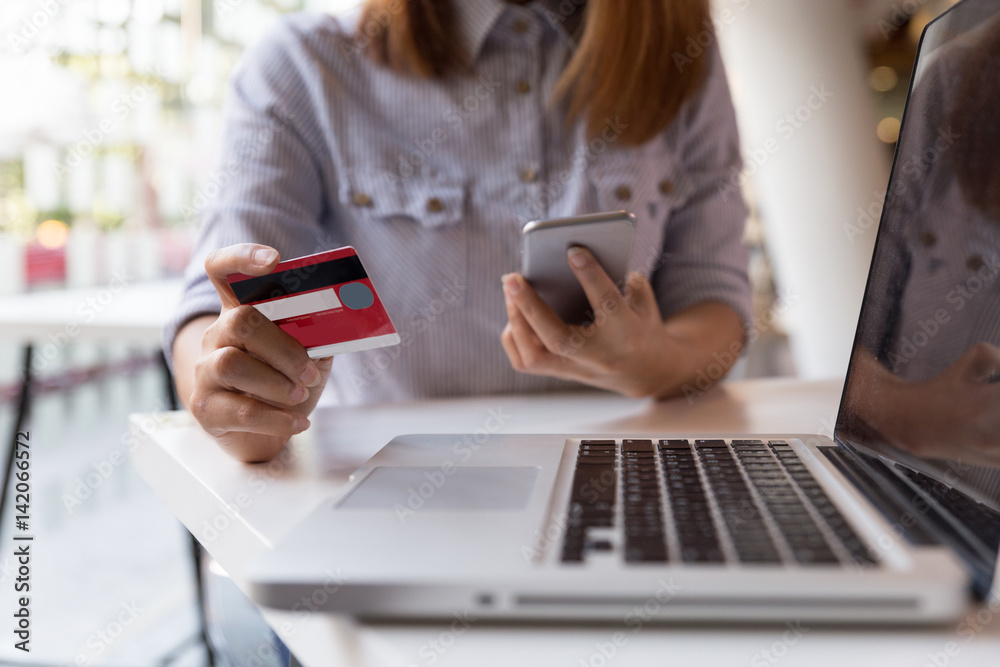 woman hands holding credit card and using mobile smart phone for online shopping. woman hands holding credit card and using mobile smart phone for online shopping.