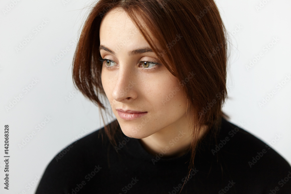 Close up portrait of thoughtful and dreamy girl feeling nostalgia, having a bit sad and lonely look while recollecting sweet moments of her happy marriage while husband is away on business trip Close up portrait of thoughtful and dreamy girl feeling nostalgia, having a bit sad and lonely look while recollecting sweet moments of her happy marriage while husband is away on business trip