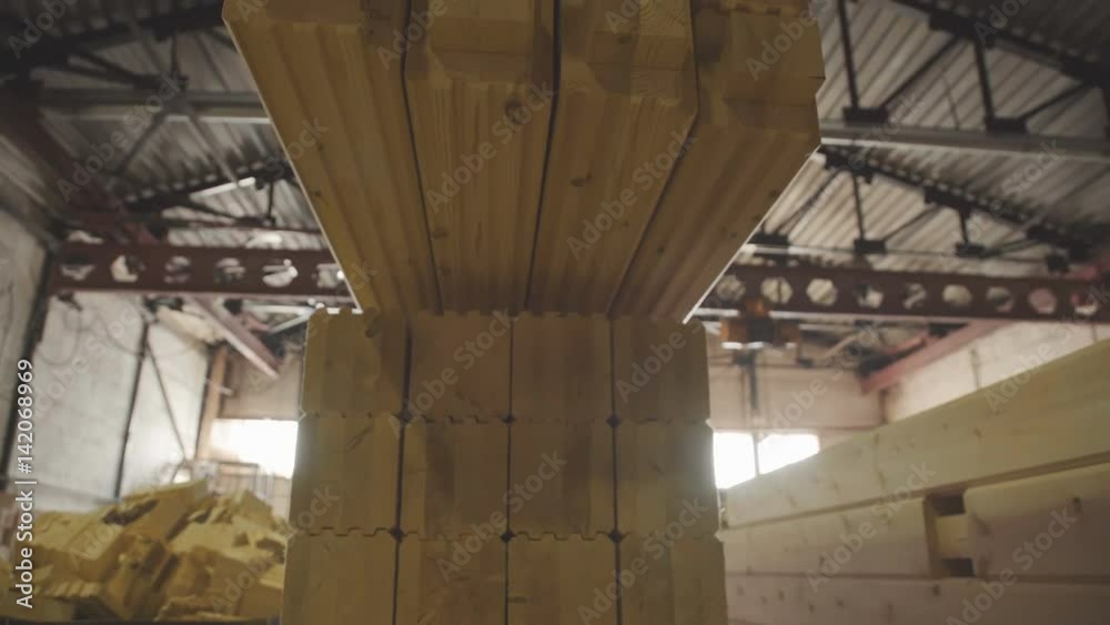 Ready glulam folded neatly in a pile. Manufacture of wood glued beams ...