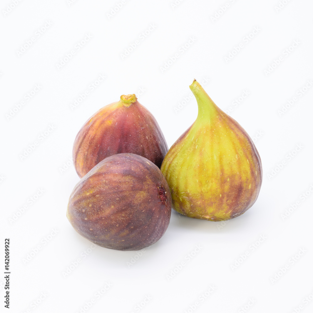 Three whole fresh fig isolate on white background. Three whole fresh fig isolate on white background.