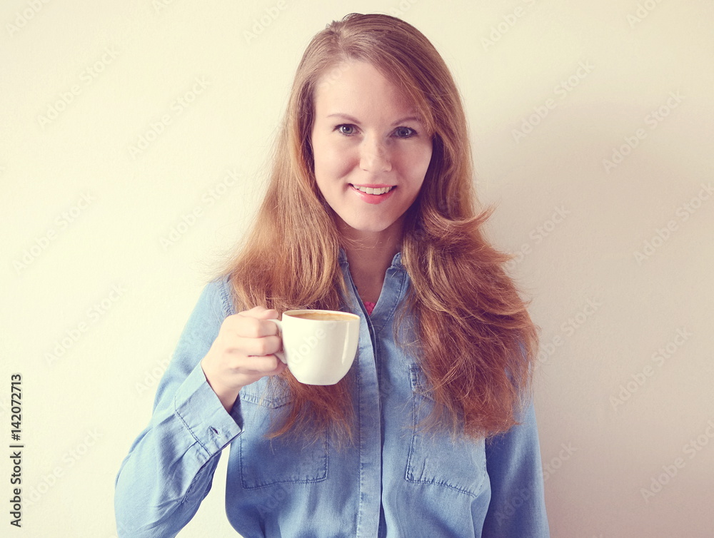 Happy beautiful young european woman smile while drinking coffee in the morning Happy beautiful young european woman smile while drinking coffee in the morning