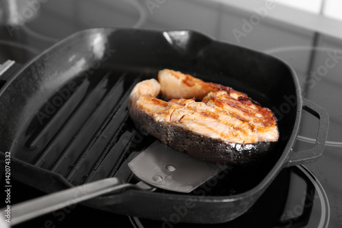 Cooking salmon steak on grill pan