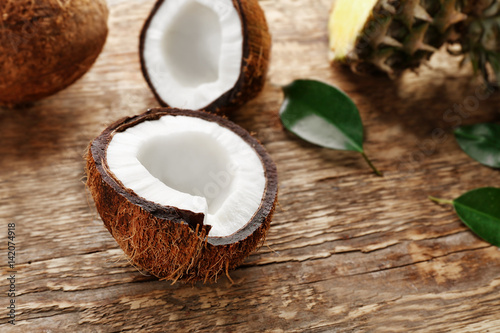 Half of fresh coconut on wooden background