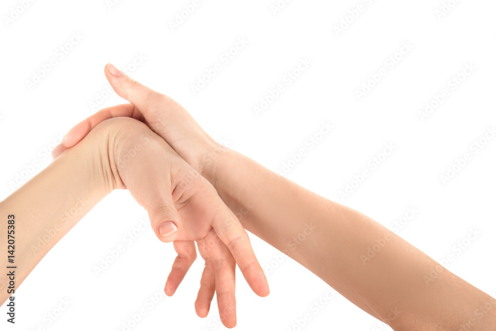 Hands of young woman suffering from pain in wrists on white background