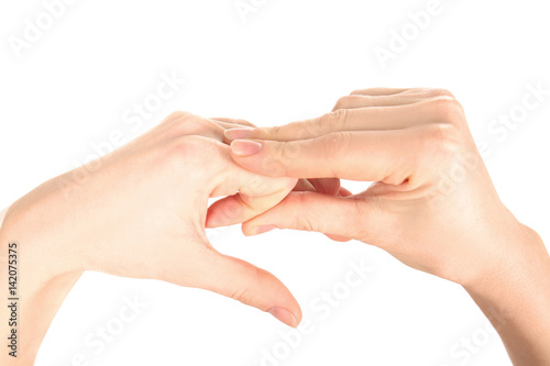 Hands of young woman suffering from pain in fingers on white background