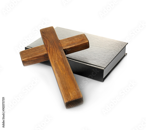 Wooden cross and Holy Bible on white background
