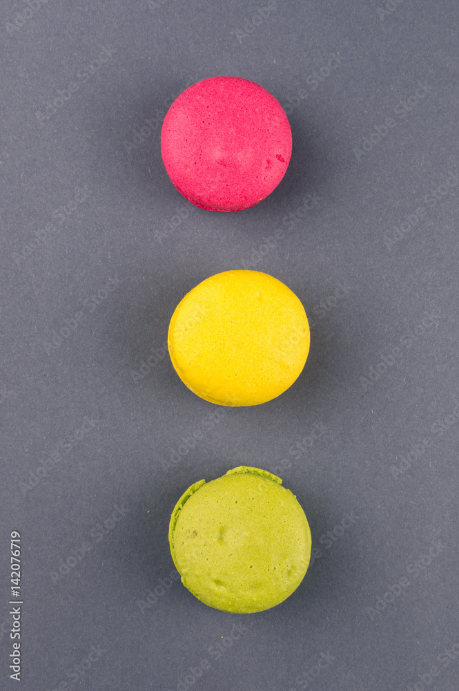 Colourful french macaroons on the grey background, Top view Colourful french macaroons on the grey background, Top view