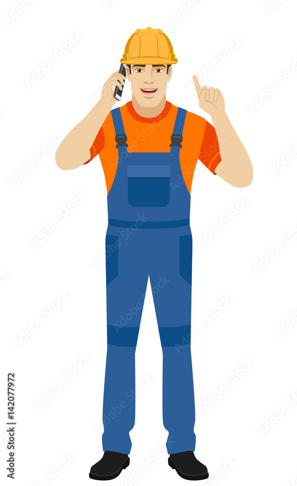 Builder talking on the mobile phone and pointing up Builder talking on the mobile phone and pointing up
